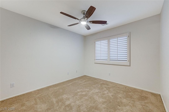 unfurnished room with ceiling fan and light carpet