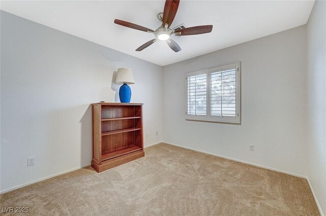 spare room featuring ceiling fan and light carpet