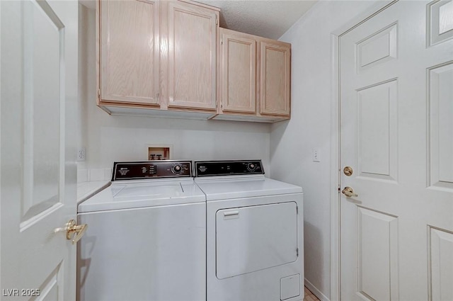 laundry area featuring cabinets and washing machine and clothes dryer