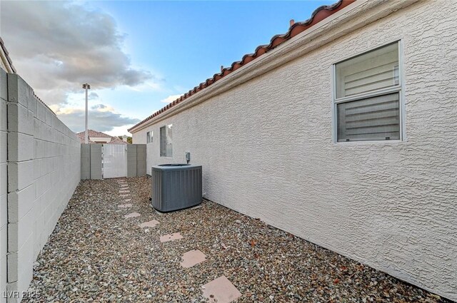 view of side of property with central air condition unit