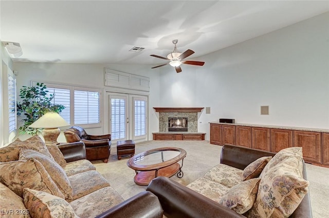 living room featuring lofted ceiling, light carpet, ceiling fan, and french doors