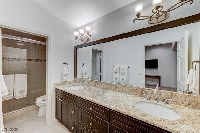 bathroom with lofted ceiling, vanity, tile patterned floors, toilet, and walk in shower