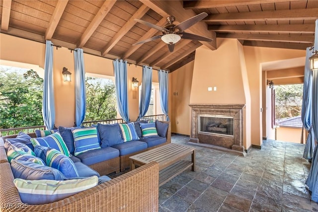 exterior space featuring an outdoor living space with a fireplace and ceiling fan