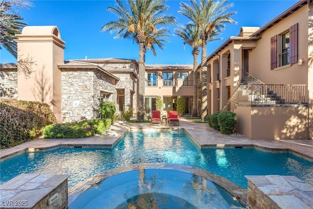 view of swimming pool with an in ground hot tub and a patio area