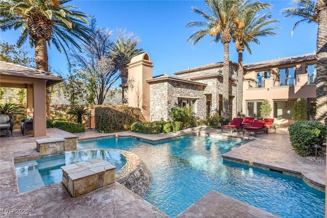 view of swimming pool featuring a patio and an in ground hot tub