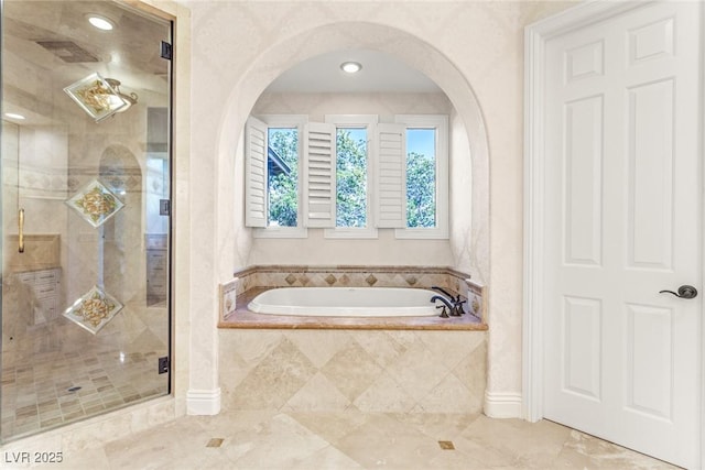 bathroom featuring tile patterned flooring and shower with separate bathtub