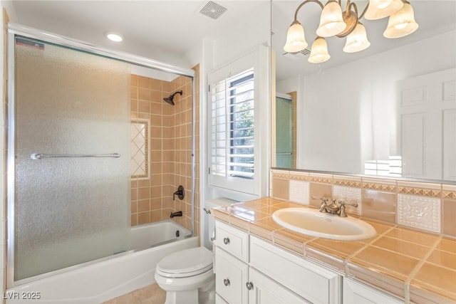 full bathroom featuring vanity, decorative backsplash, toilet, and combined bath / shower with glass door