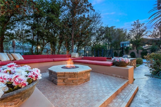 view of patio featuring an outdoor living space with a fire pit