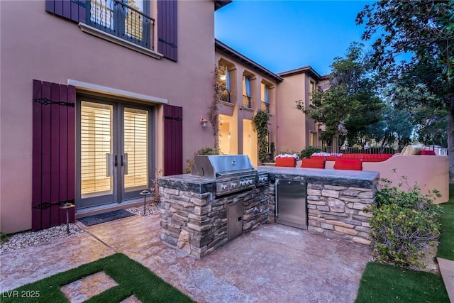 view of patio / terrace featuring exterior kitchen, grilling area, and french doors