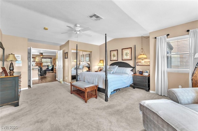 carpeted bedroom featuring lofted ceiling, a closet, and ceiling fan