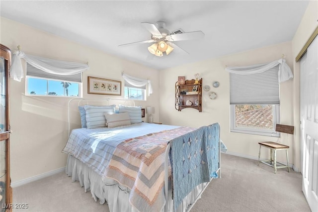 bedroom with ceiling fan, a closet, and light carpet