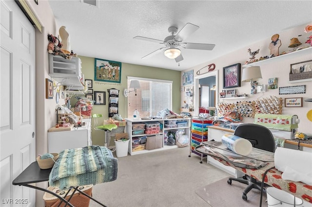 carpeted office with ceiling fan and a textured ceiling