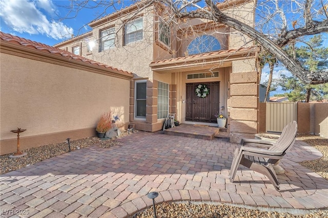 view of exterior entry with a patio