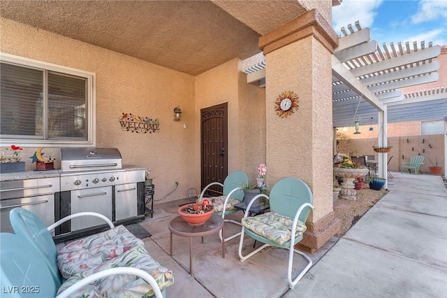 view of patio / terrace with a grill, a pergola, and exterior kitchen