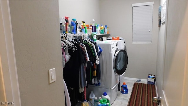 laundry area featuring laundry area, baseboards, and washing machine and clothes dryer