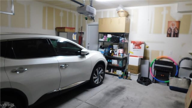 garage featuring a garage door opener and a wall mounted air conditioner