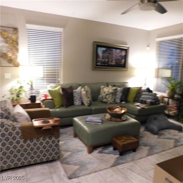 living area featuring a ceiling fan