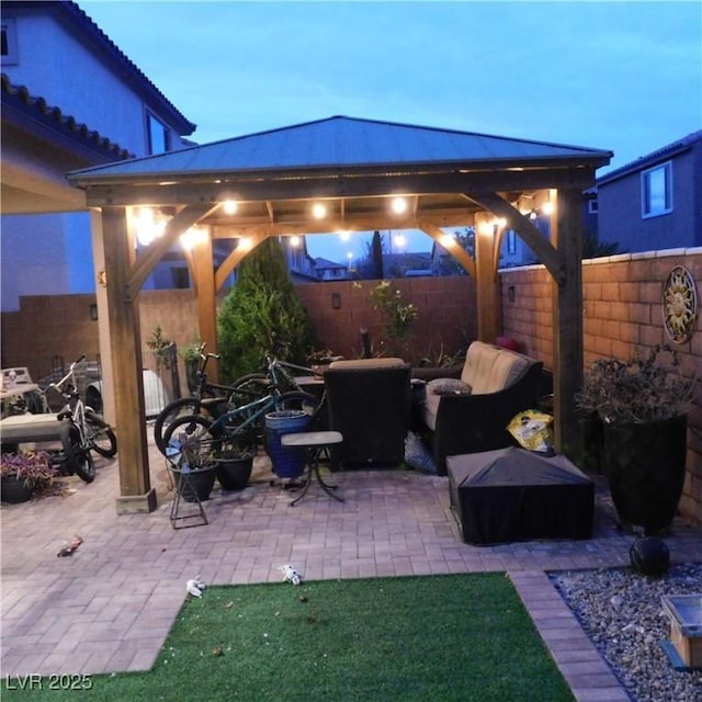 view of patio featuring a gazebo and a fenced backyard