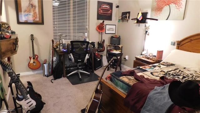 carpeted bedroom featuring baseboards