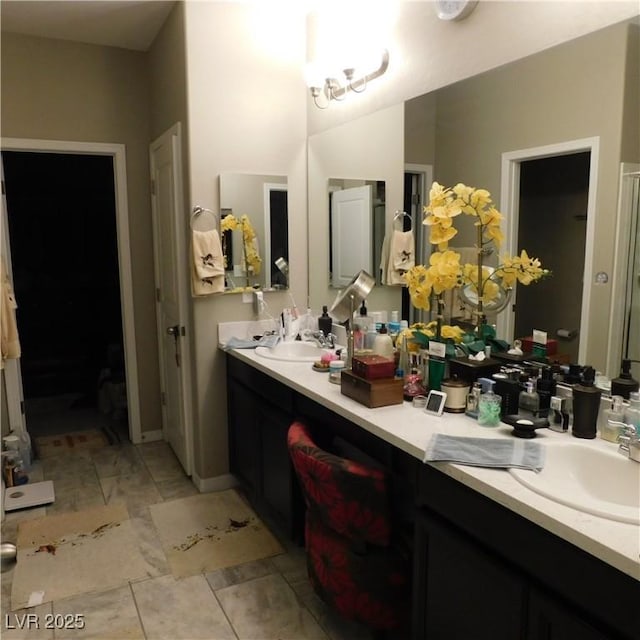 full bathroom with double vanity and a sink