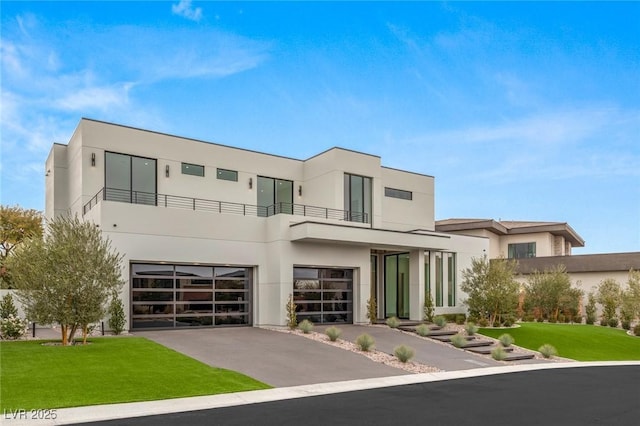 modern home featuring a garage and a front lawn