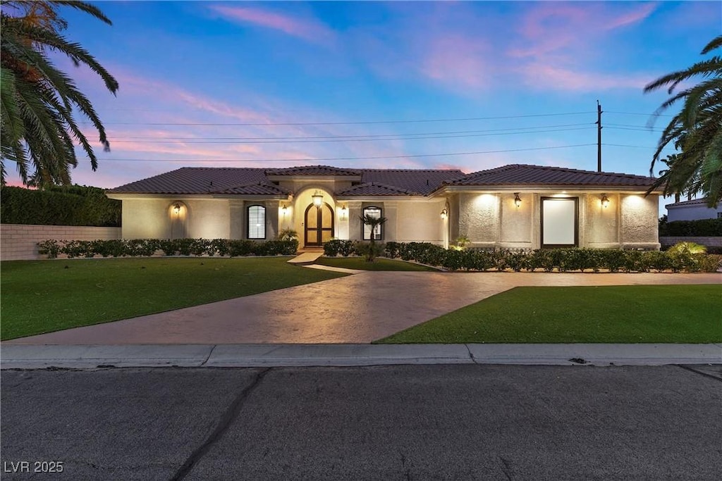 mediterranean / spanish-style home featuring a lawn