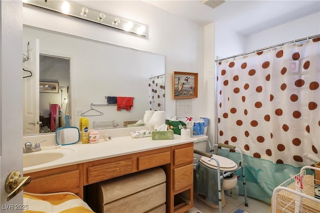 bathroom with vanity, curtained shower, and tile patterned floors