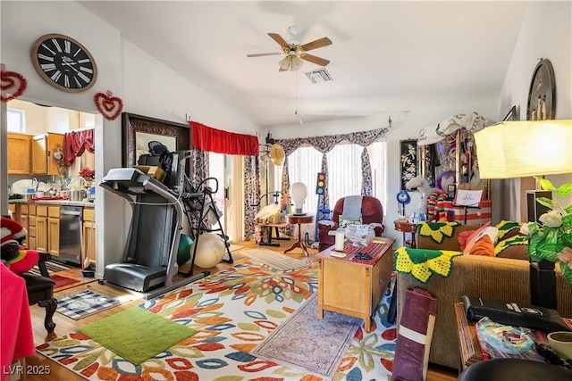 interior space featuring ceiling fan, plenty of natural light, vaulted ceiling, and light hardwood / wood-style flooring