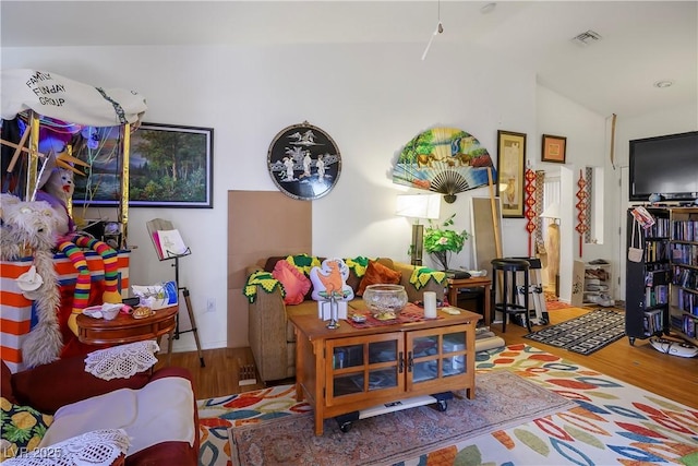 interior space featuring hardwood / wood-style flooring and lofted ceiling