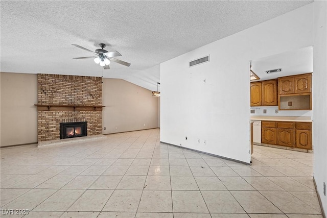 unfurnished living room with light tile patterned floors, vaulted ceiling, ceiling fan, and a brick fireplace