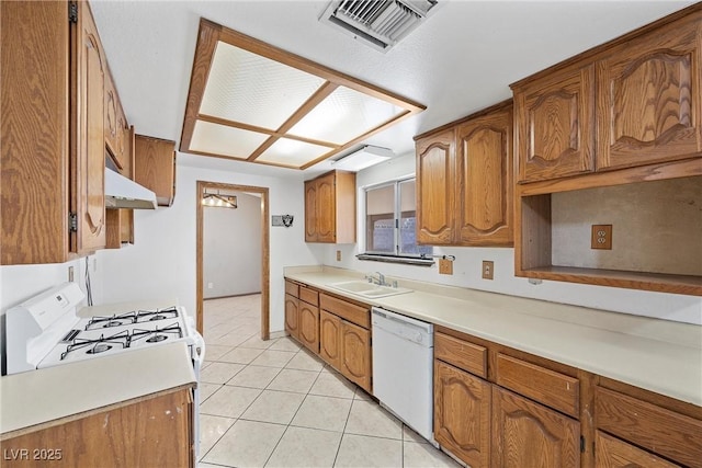 kitchen with white appliances, sink, and light tile patterned floors