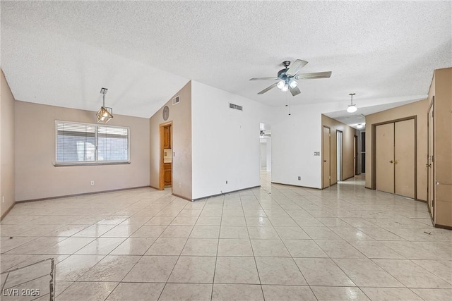 unfurnished room featuring light tile patterned floors, a textured ceiling, and ceiling fan