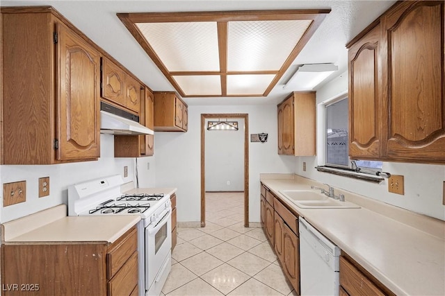 kitchen featuring sink, white appliances, and light tile patterned floors