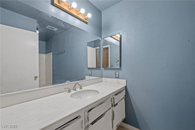 bathroom with vanity and walk in shower