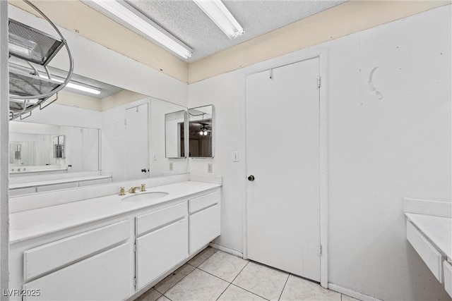 bathroom with vanity, tile patterned flooring, and a textured ceiling