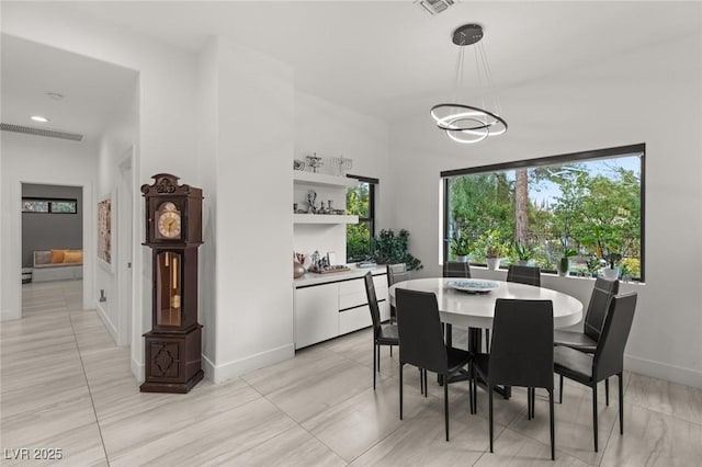 dining space with an inviting chandelier