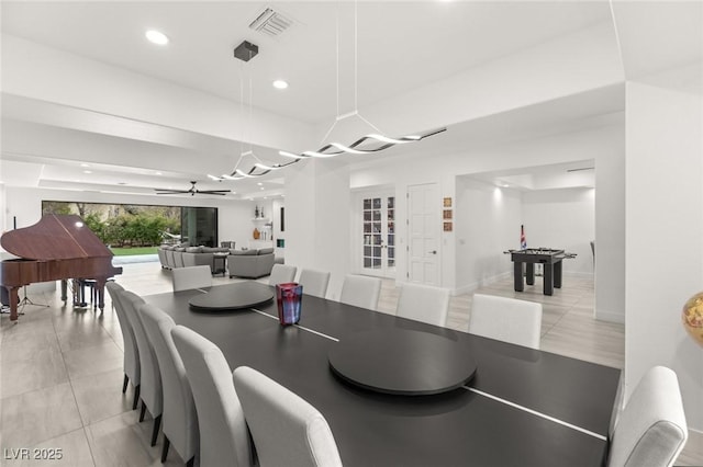 tiled dining space featuring ceiling fan