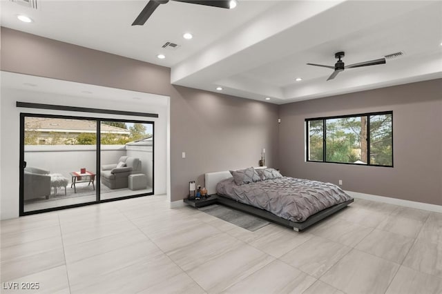 bedroom featuring ceiling fan, access to exterior, and a raised ceiling