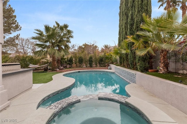 view of pool with an in ground hot tub