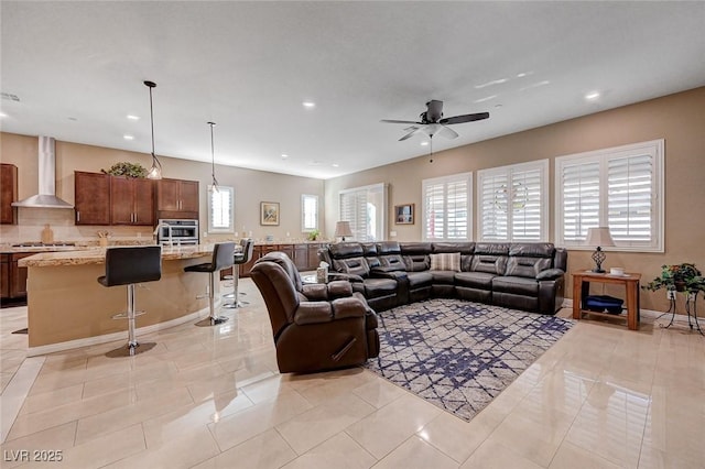 tiled living room with ceiling fan