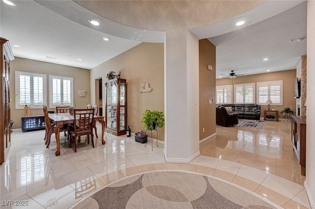 tiled dining area with ceiling fan