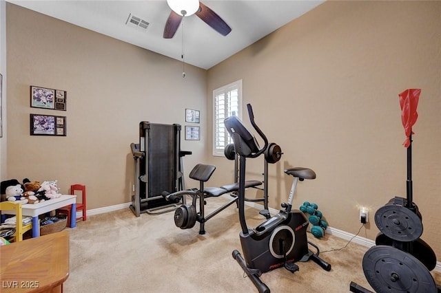 exercise room with ceiling fan and light colored carpet