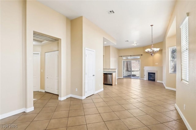 unfurnished living room featuring light tile patterned flooring and a notable chandelier