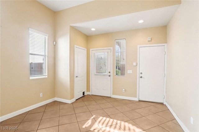 foyer entrance with light tile patterned floors