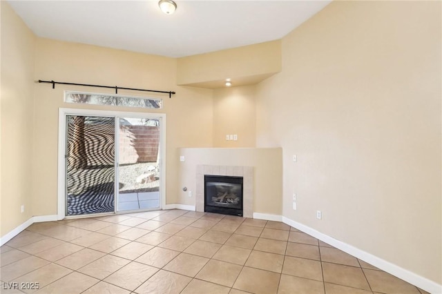 unfurnished living room featuring a tiled fireplace and light tile patterned flooring