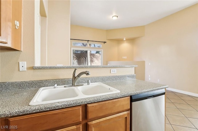 kitchen with light tile patterned flooring, dishwasher, and sink