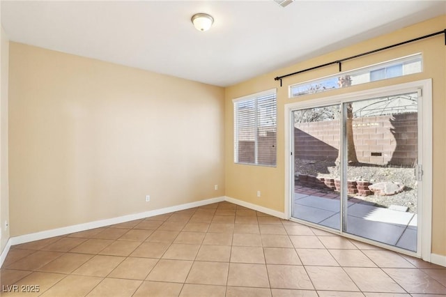 spare room featuring light tile patterned flooring