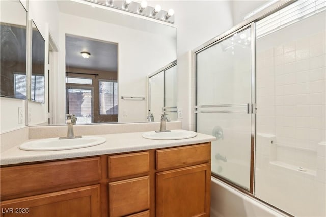 bathroom featuring vanity and bath / shower combo with glass door