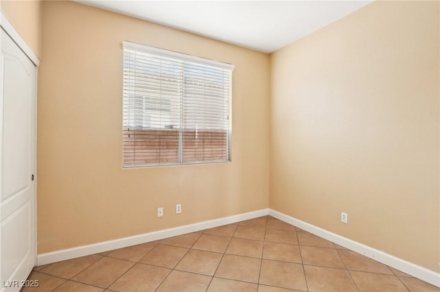 unfurnished room featuring light tile patterned flooring