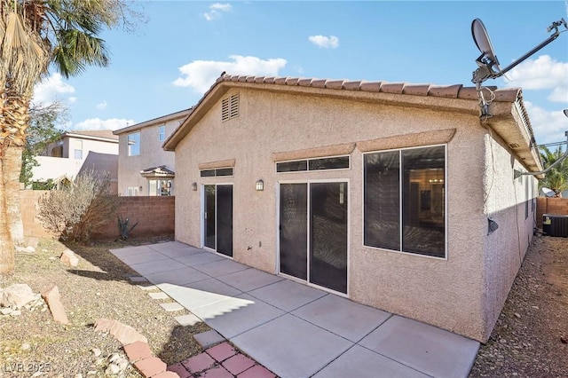 rear view of house with a patio and central air condition unit